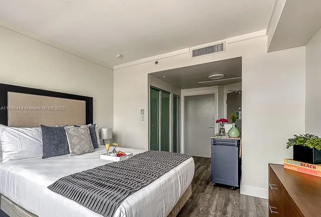 a bedroom with a bed and a potted plant