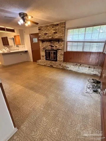 a view of a livingroom with furniture and a fireplace