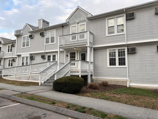 a view of a white building among the front of a house