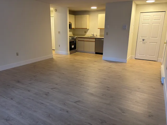 a kitchen with granite countertop a sink and stainless steel appliances