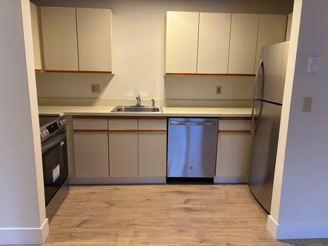 a kitchen with stainless steel appliances granite countertop a refrigerator sink and cabinets