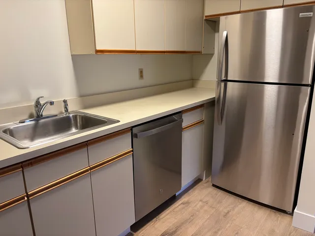 a kitchen with stainless steel appliances a refrigerator and a sink