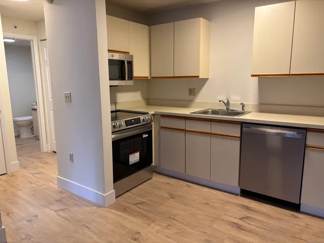 a kitchen with a sink stove and cabinets