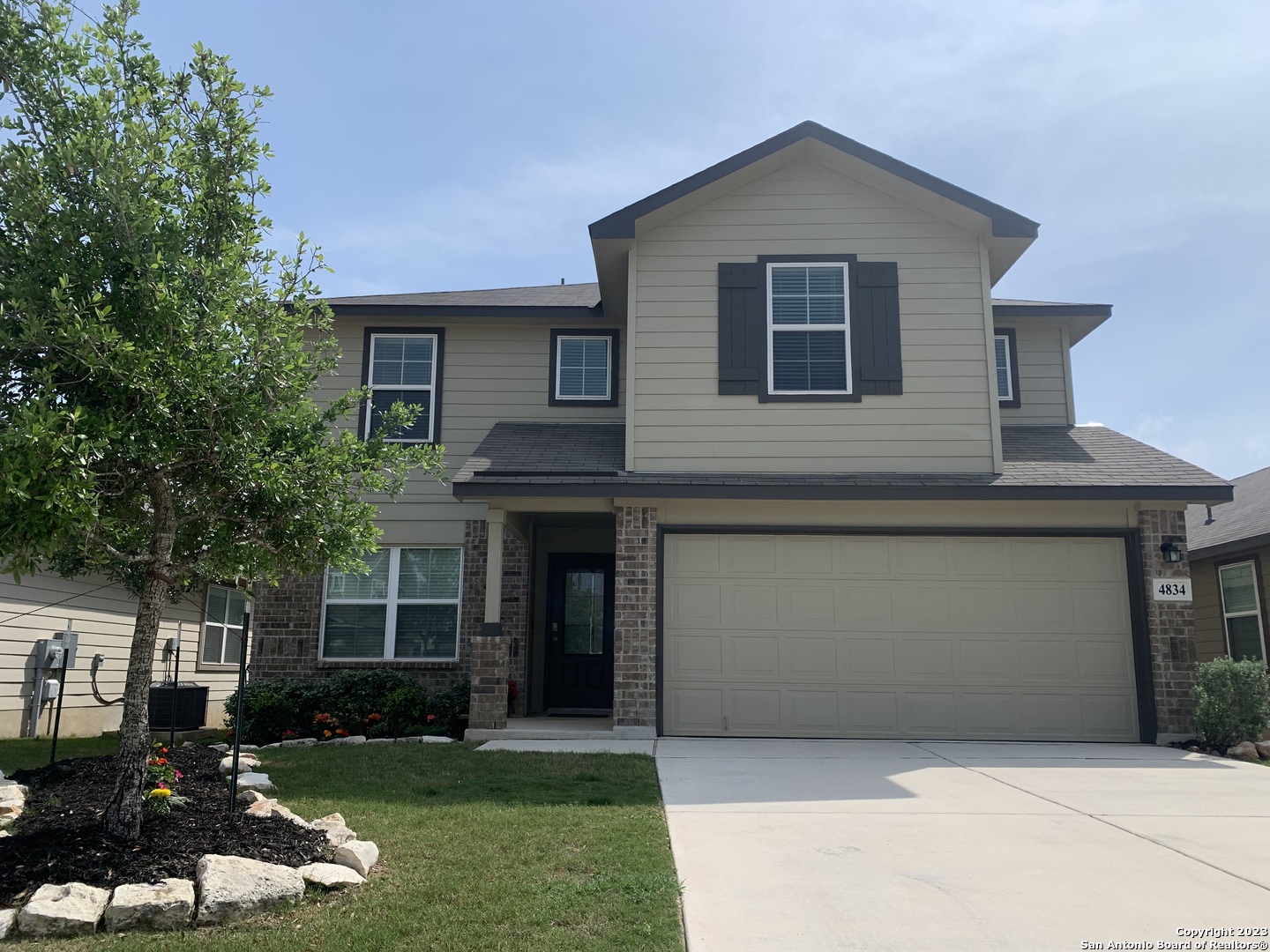 a front view of a house with a yard and garage