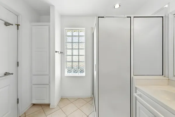 a bathroom with a shower and a sink