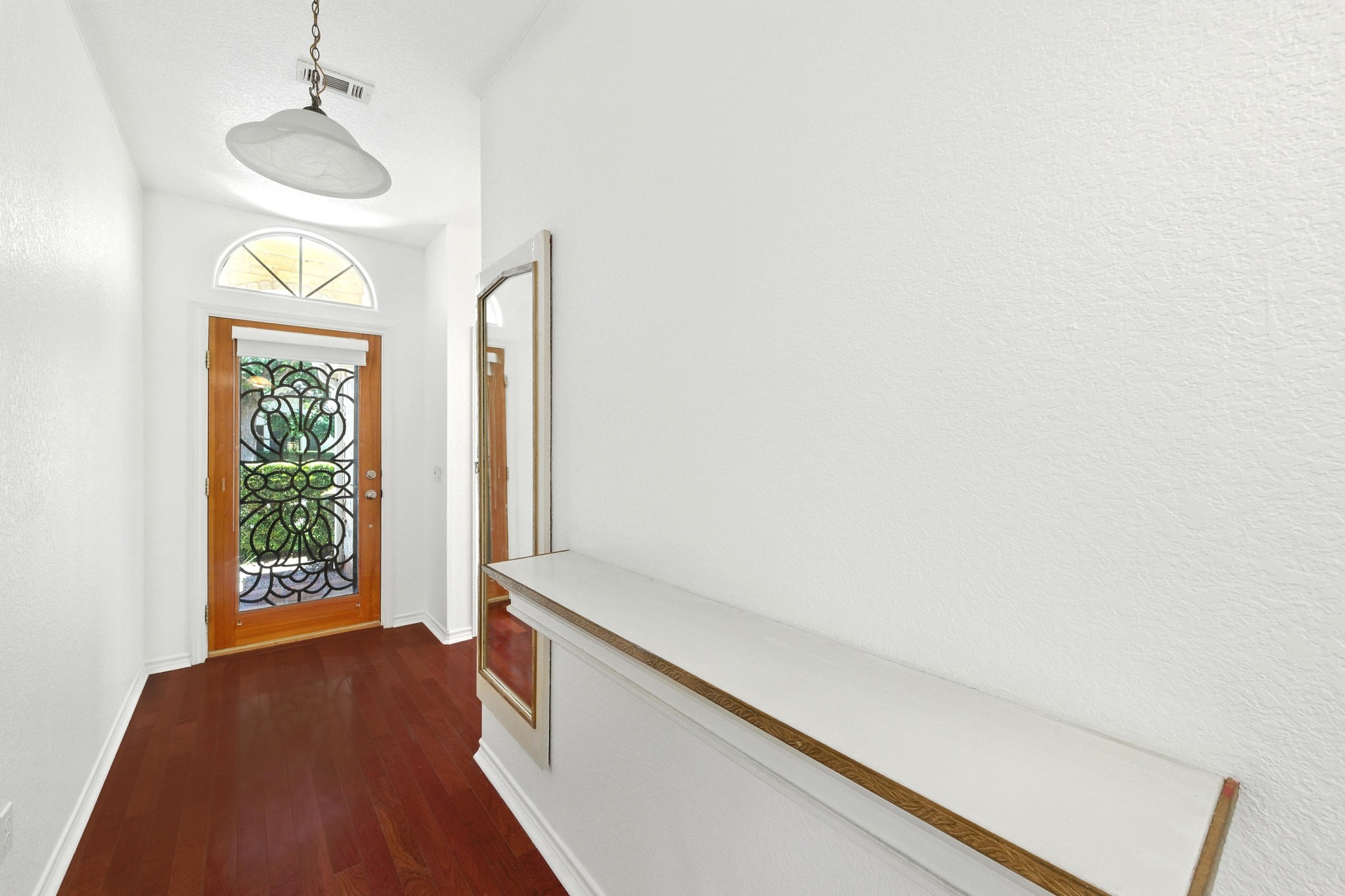 125 Melissa Court Georgetown, TX 78628 - Photo 19 of 29 a hallway with sliding door and chandelier