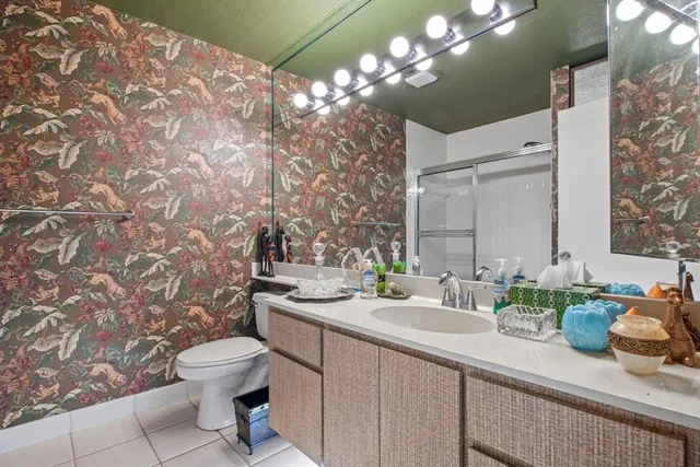 a bathroom with a sink mirror and toilet
