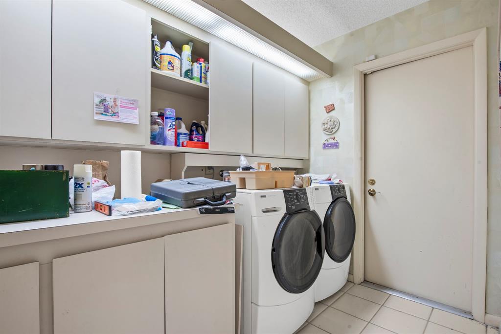 119 Beach Summit Court Jupiter, FL 33477 - Photo 12 of 23 a utility room with dryer washer and a fridge