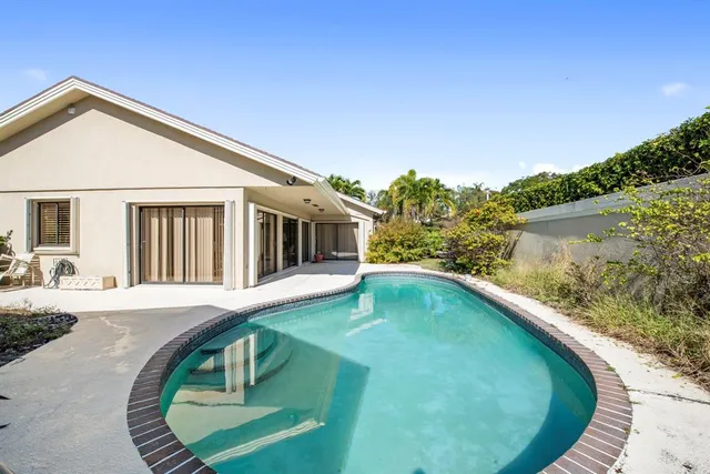 a swimming pool with trees in the background