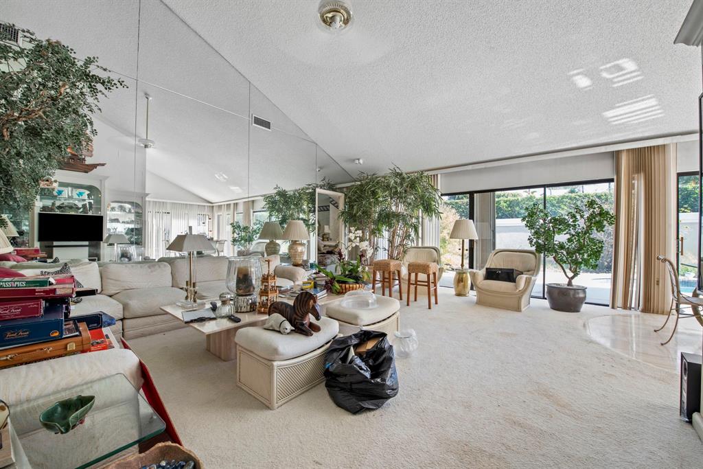 119 Beach Summit Court Jupiter, FL 33477 - Photo 4 of 23 a room with gym equipment and a large window