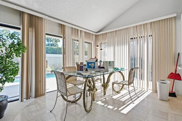 a view of a dining room with furniture and front door