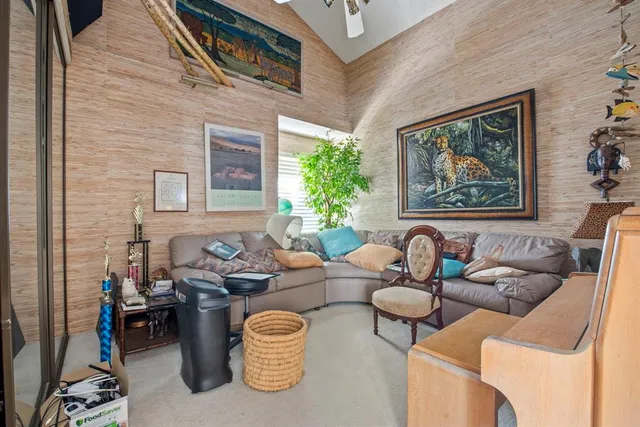 a living room with furniture and a potted plant