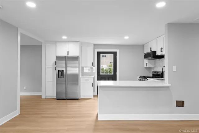a kitchen with stainless steel appliances a refrigerator sink and microwave