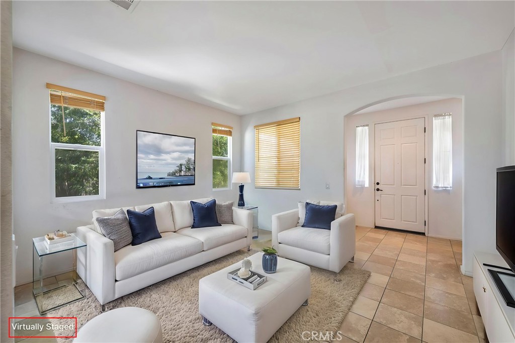 3819 St Austell Way Perris, CA 92571 - Photo 6 of 64 a living room with furniture and a flat screen tv