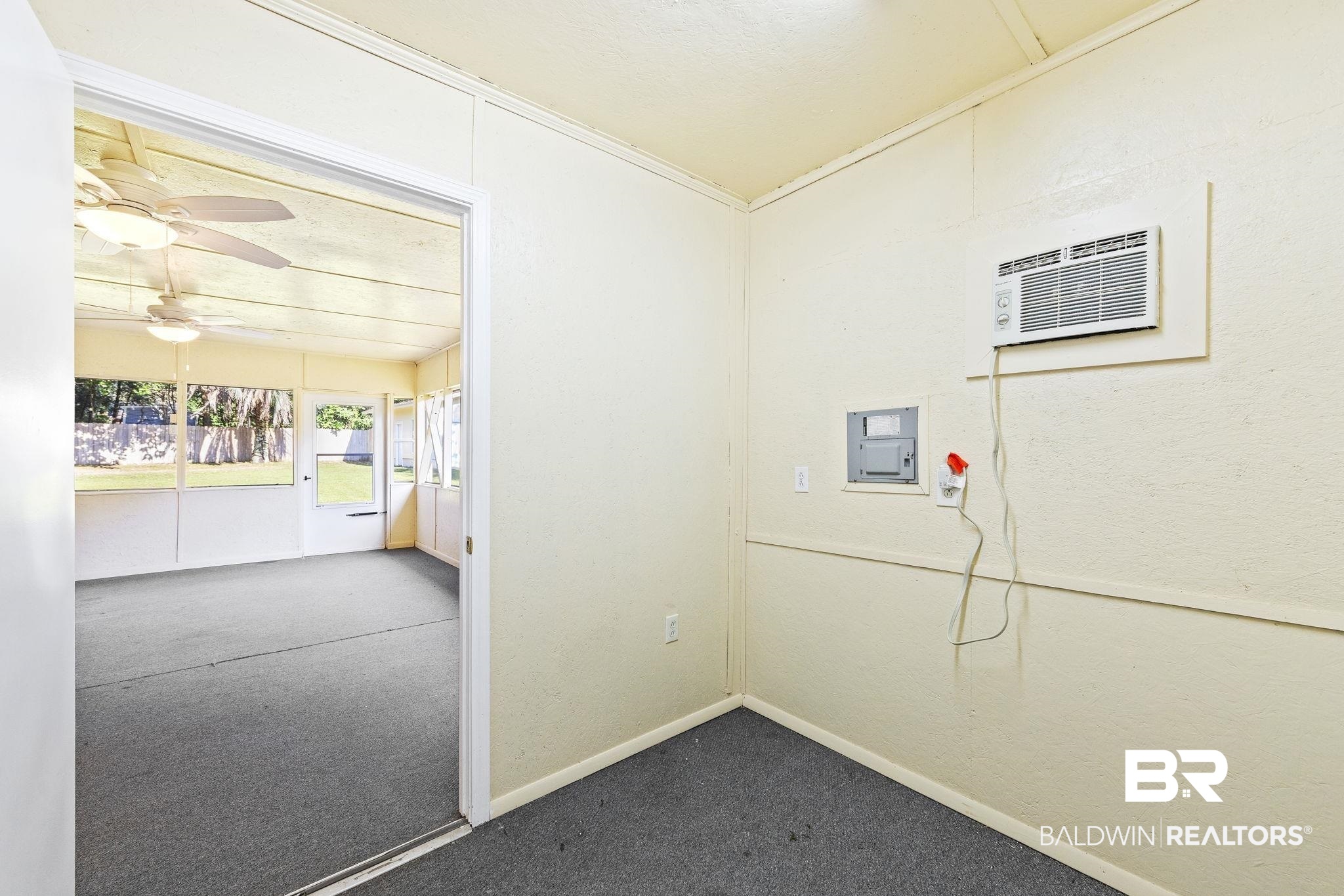 4366 Barden Avenue Mobile, AL 36619 - Photo 19 of 40 Interior space featuring ceiling fan, electric panel, a wall mounted AC, carpet, and crown molding