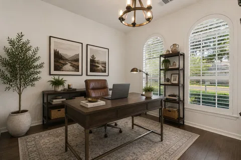 a work room with furniture and a large window