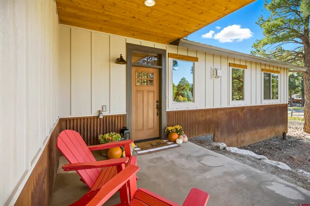 a backyard of a house with outdoor seating