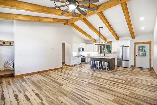 a kitchen with stainless steel appliances granite countertop a sink and a white cabinets