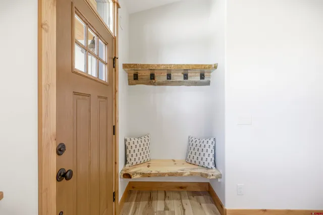 a view of a room with wooden floor