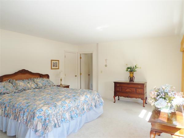 17-23 North Street Three Rivers, MA 01080 - Photo 7 of 29 a bedroom with a bed table and a chair