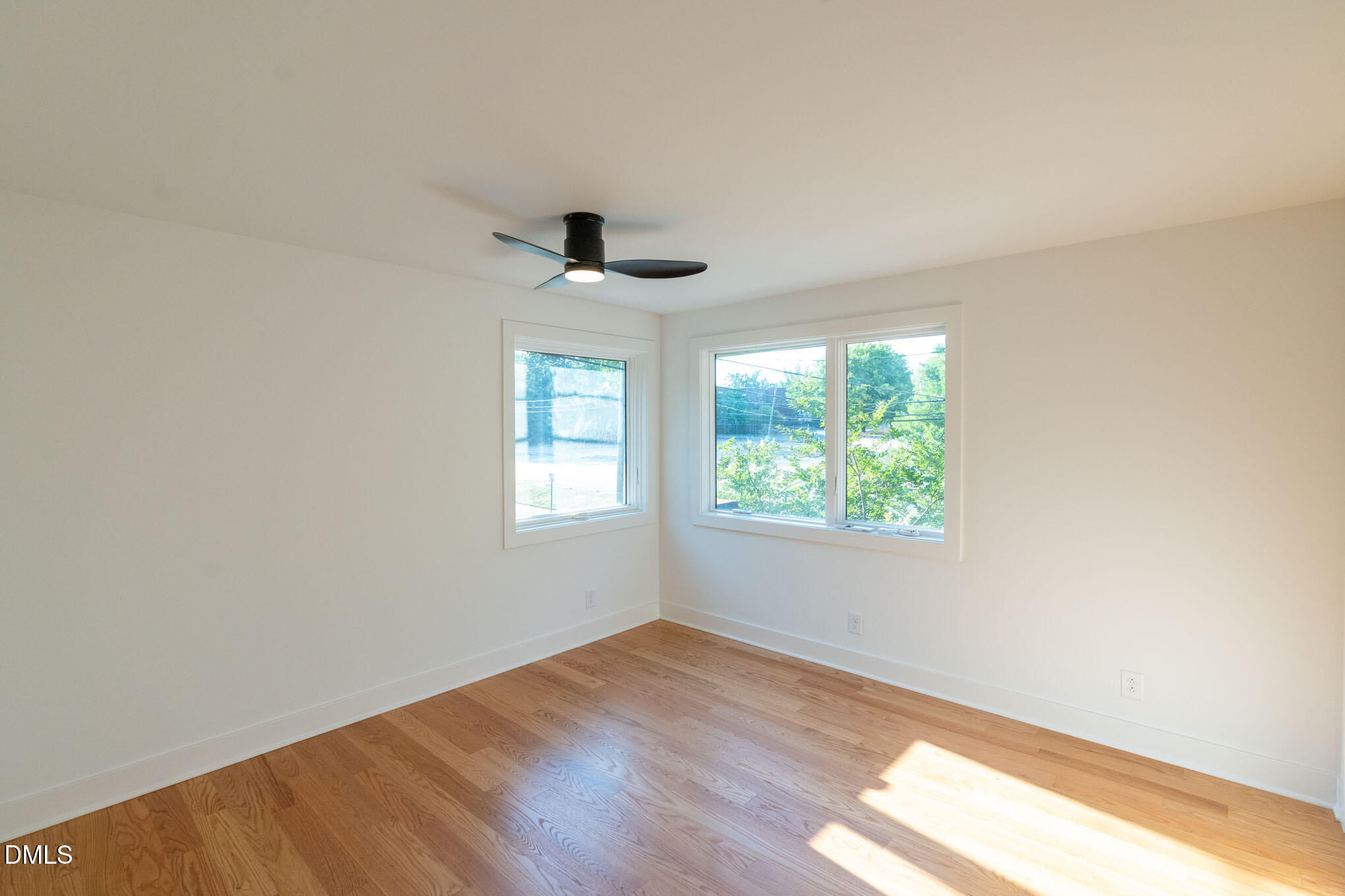 402 East Martin Street Raleigh, NC 27601 - Photo 17 of 23 an empty room with a window and a ceiling fan