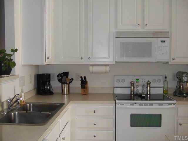 4806 Black Mountain Path Raleigh, NC 27612 - Photo 3 of 12 a kitchen with white cabinets and a sink