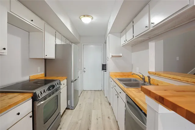 a kitchen that has a sink and a stove