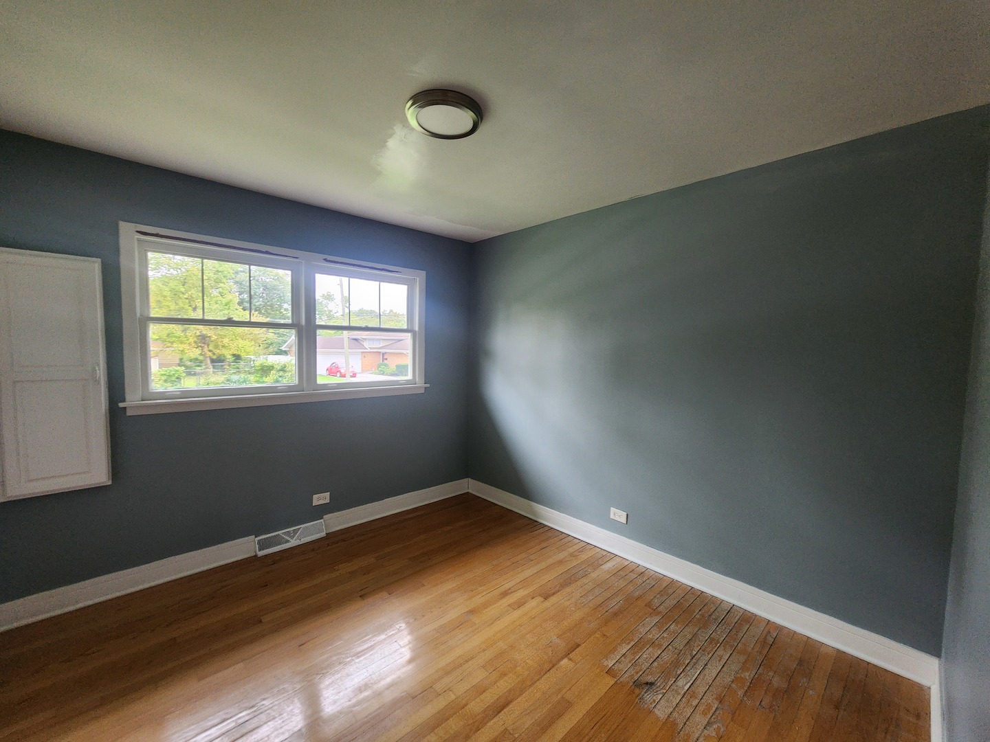 1208 Evergreen Road Homewood, IL 60430 - Photo 12 of 12 an empty room with wooden floor and windows