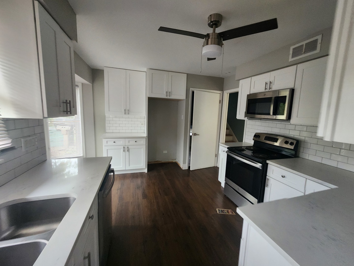1208 Evergreen Road Homewood, IL 60430 - Photo 7 of 12 a kitchen with stainless steel appliances a stove microwave and a refrigerator