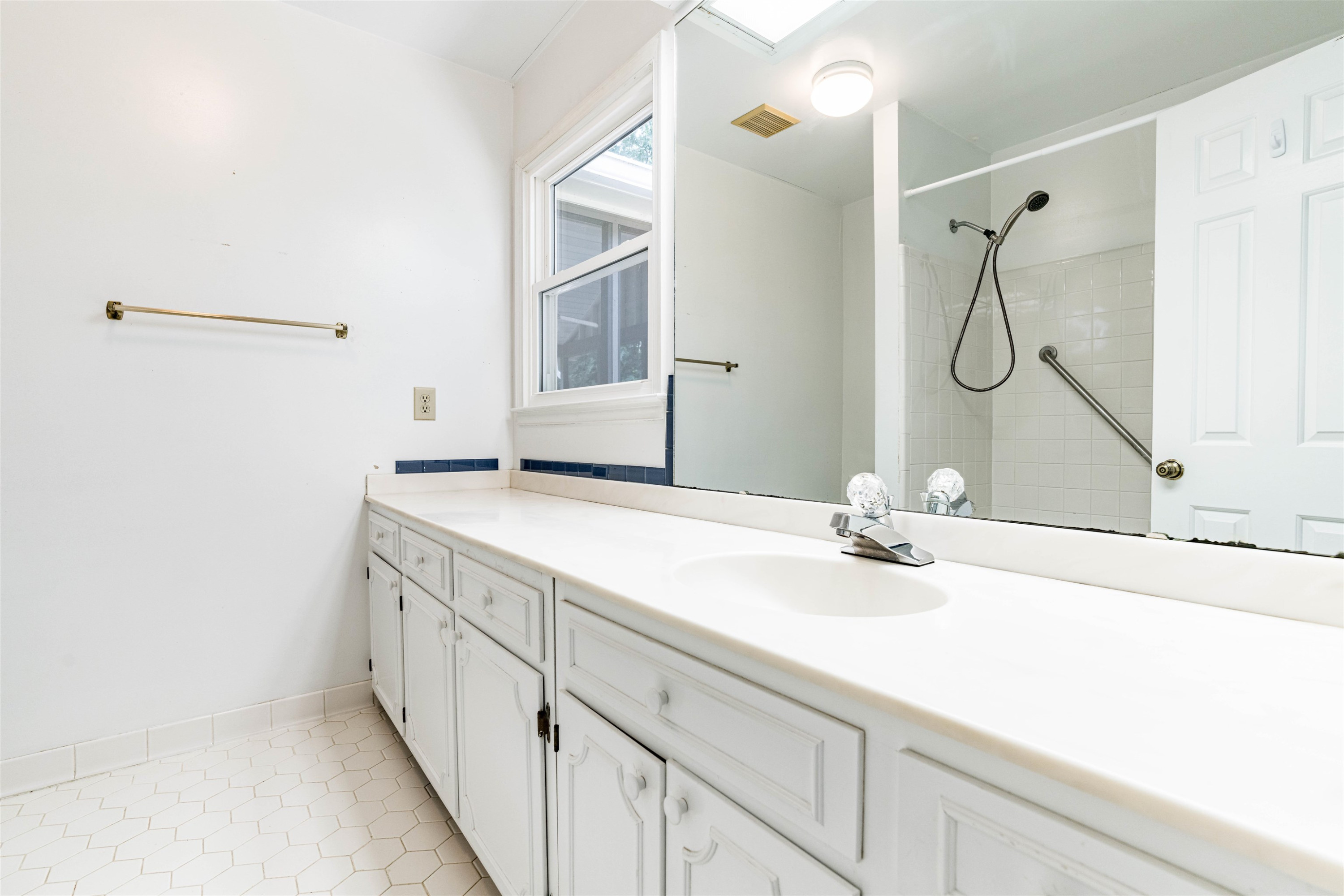 3013 Rue Sans Famille Raleigh, NC 27607 - Photo 12 of 16 a bathroom with a granite countertop sink and a mirror
