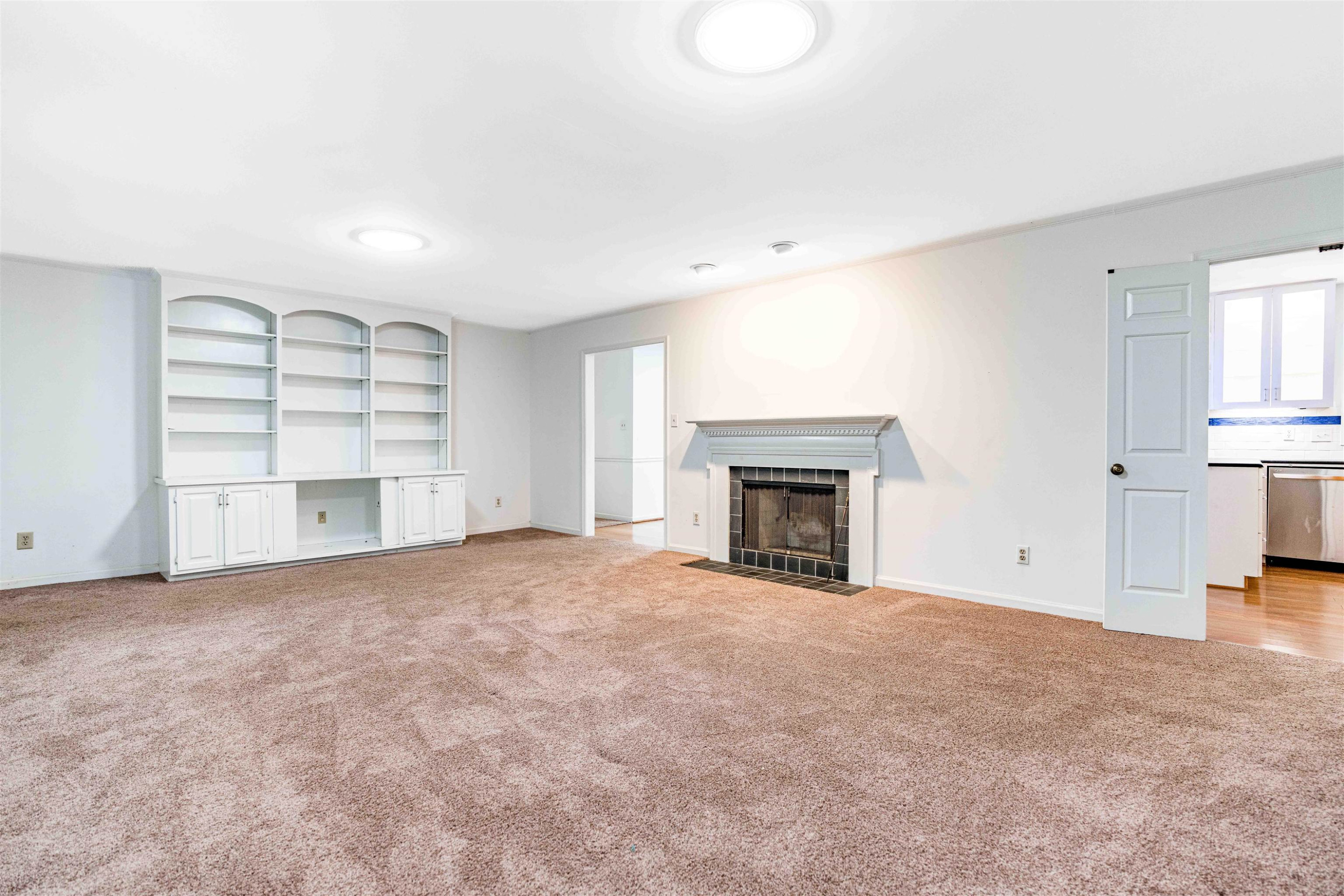 3013 Rue Sans Famille Raleigh, NC 27607 - Photo 7 of 16 an empty room with a fireplace cabinet and window