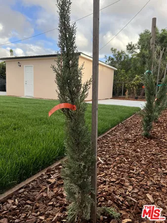 a view of a big yard with an outdoor seating