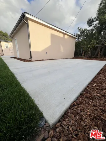 a view of a big house with a big yard and large trees