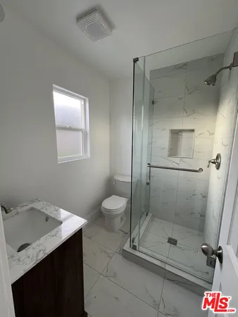 a view of room with window and wooden floor