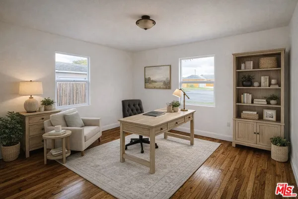 a living room with furniture and wooden floor