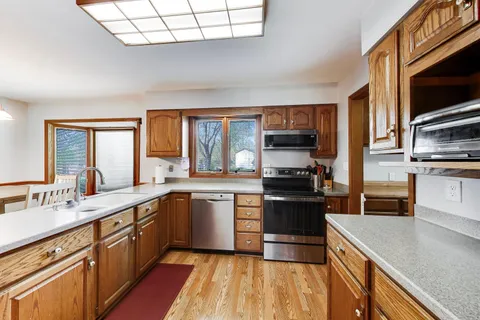 a living room with dining table and a large window
