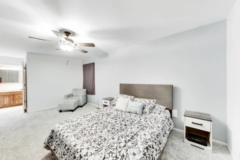 a bedroom with a bed and a chandelier