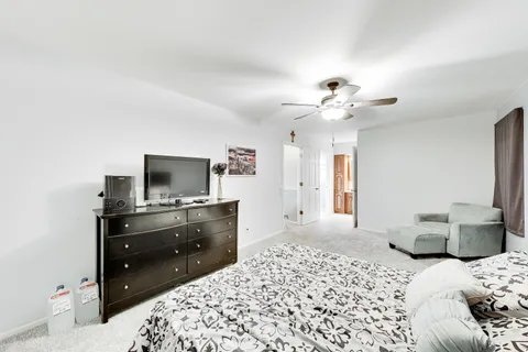 a bedroom with a bed and a chandelier