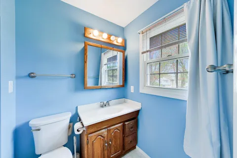 a bedroom with furniture and a wooden floor