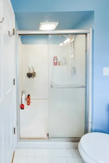 a en suite spacious bedroom with a bed and a window