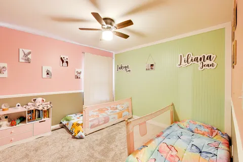 a bedroom with a bed and a large window with the outer view