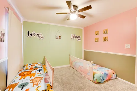 a bedroom with a bed and a chandelier