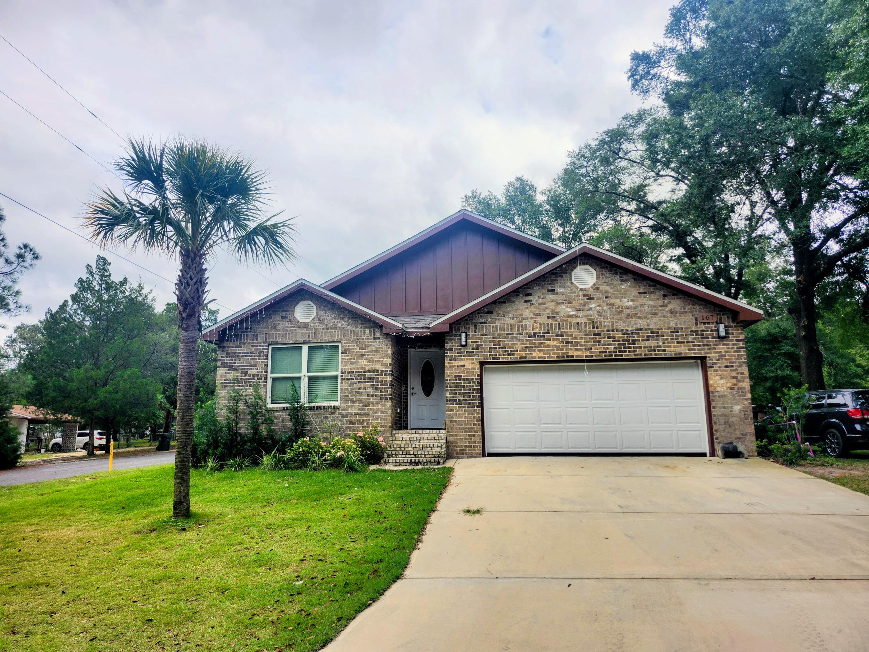 167 Apache Drive DeFuniak Springs, FL 32435 - Photo 1 of 18 a view of a house with a yard and potted plants