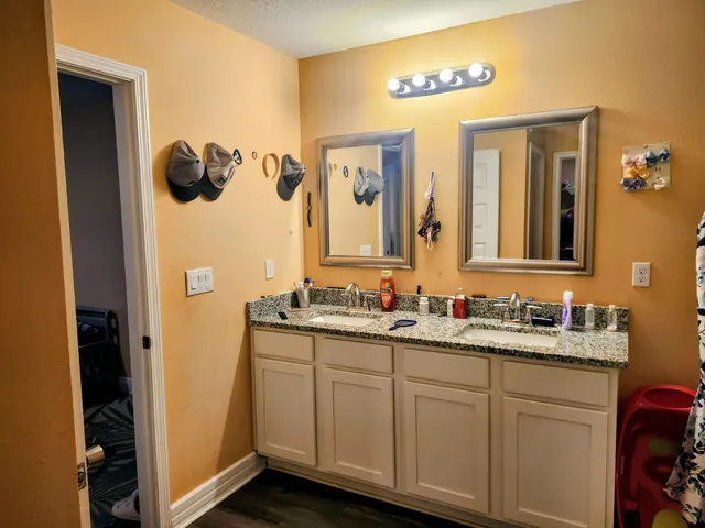 a bathroom with a double vanity sink and a mirror