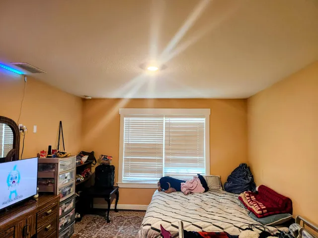 a bedroom with a bed and a window