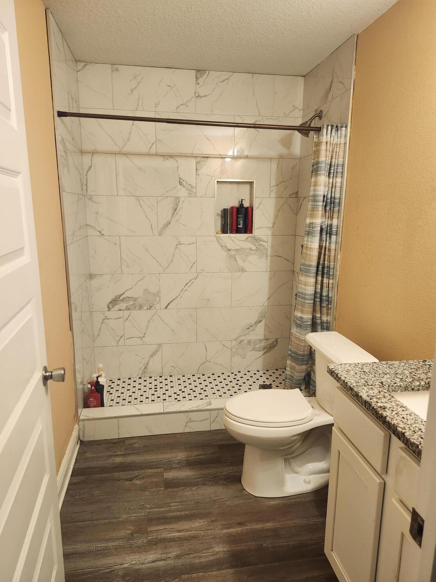 167 Apache Drive DeFuniak Springs, FL 32435 - Photo 5 of 18 a bathroom with a granite countertop sink toilet and shower