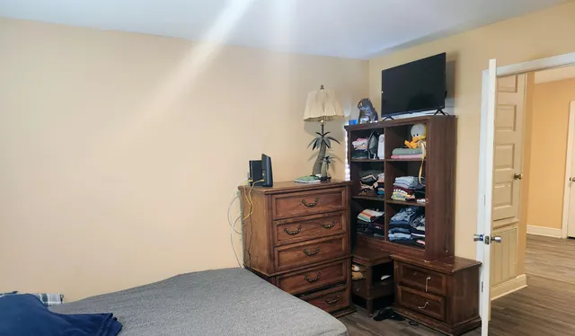 a view of a bedroom with cabinets