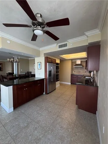 a living room with lots of furniture and a chandelier
