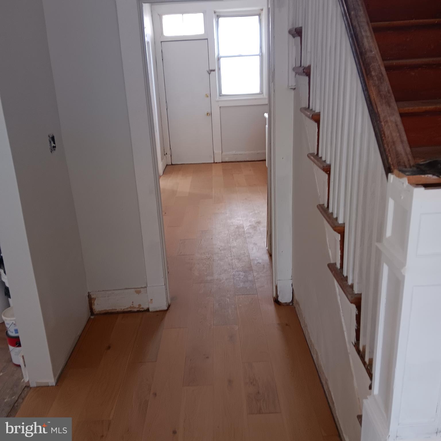 2419 Mosher Street Baltimore, MD 21216 - Photo 16 of 19 a view of a hallway with wooden floor and staircase