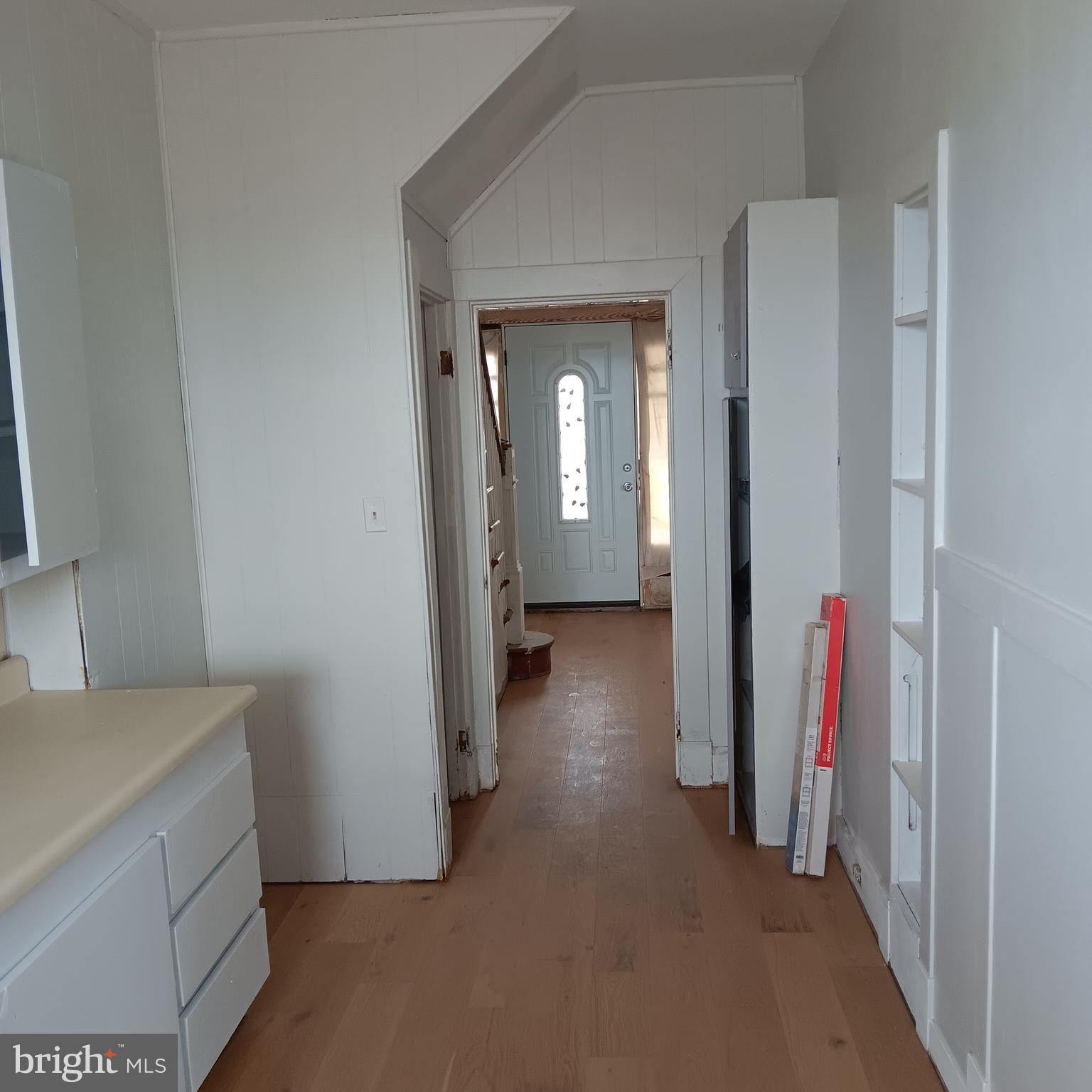 2419 Mosher Street Baltimore, MD 21216 - Photo 2 of 19 a view of a hallway with wooden floor